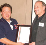 Ralph Hauselmann receives the SAIMC presenters’ certificate from Alvin Seitz